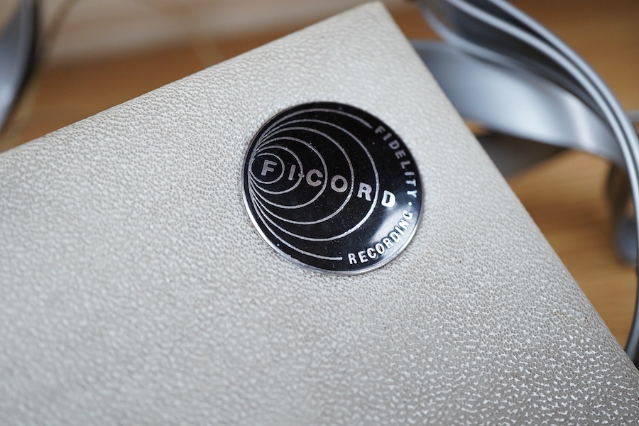 A late 1950s portable 9v battery powered reel-to-reel FI-Cord 1A, ‘Fidelity Recording’, as used by BBC reporters, with original vinyl strap and earphone